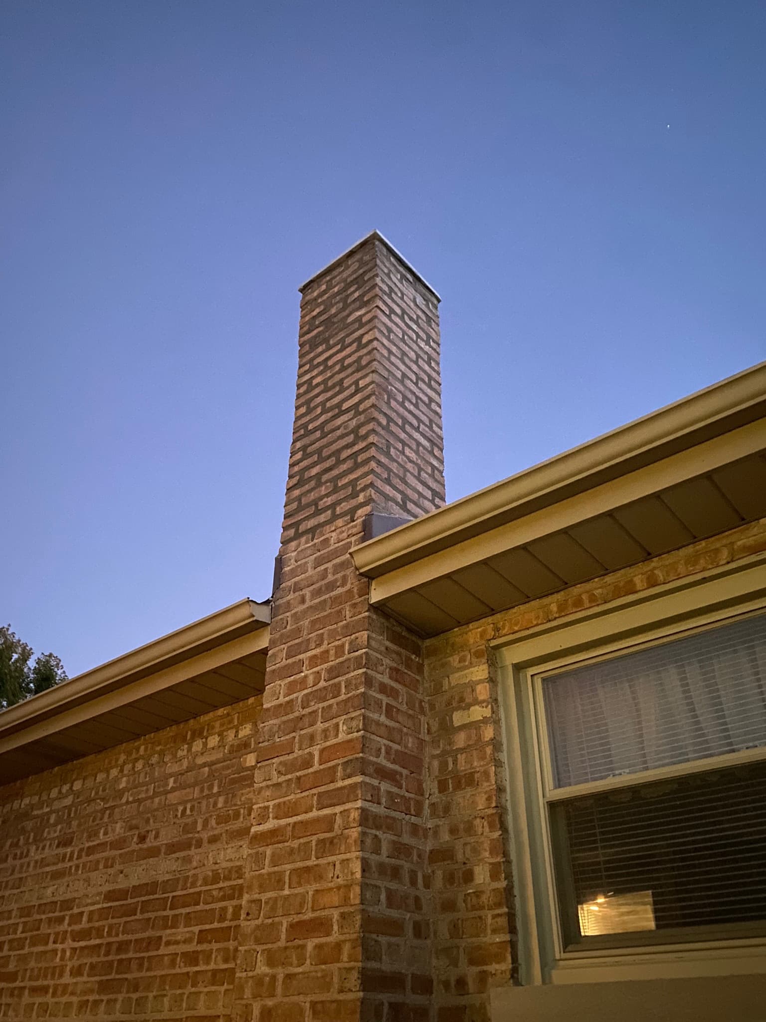 Repaired and repointed brick chimney on a residential home in Mokena Illinois Will County