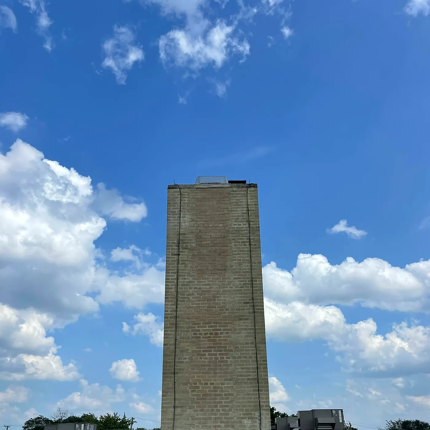 Rooftop commercial chimney stack after full masonry rebuild