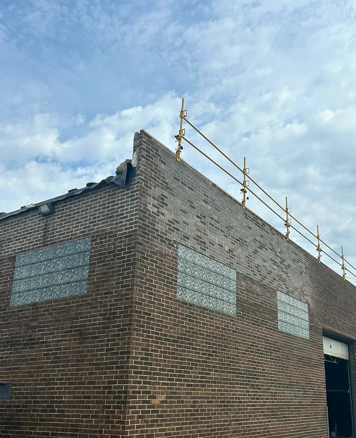 Commercial parapet wall repair with new coping on a brick building