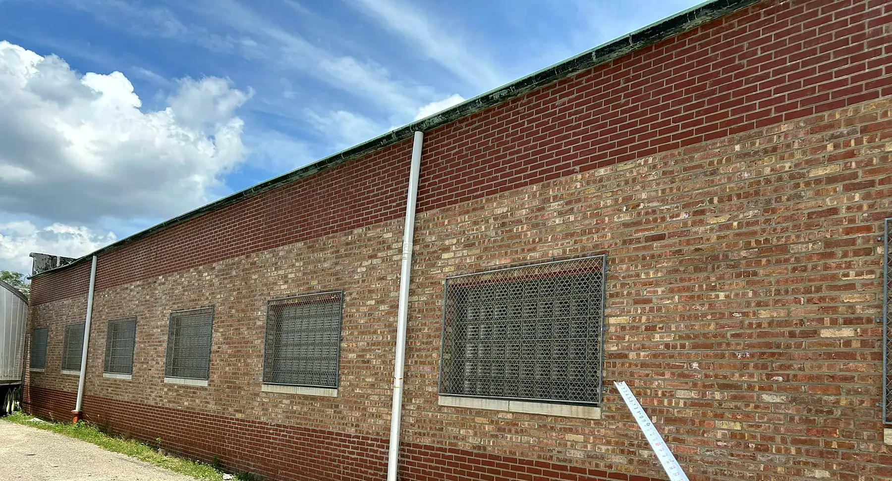 Warehouse brick wall after full-height commercial tuckpointing