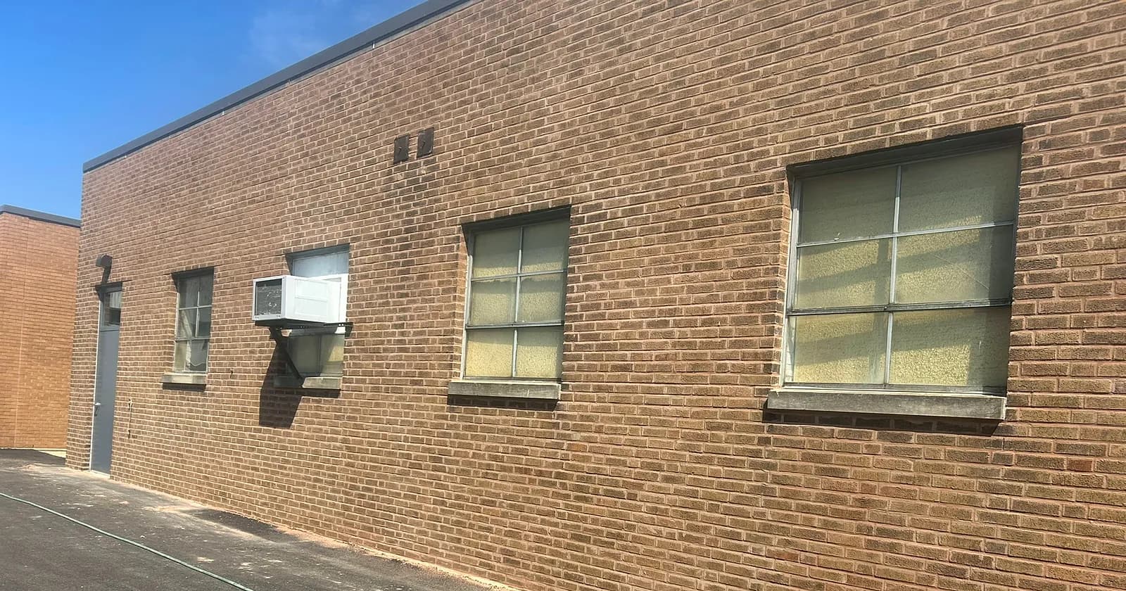 Commercial window wall with repaired lintels and repointed mortar joints