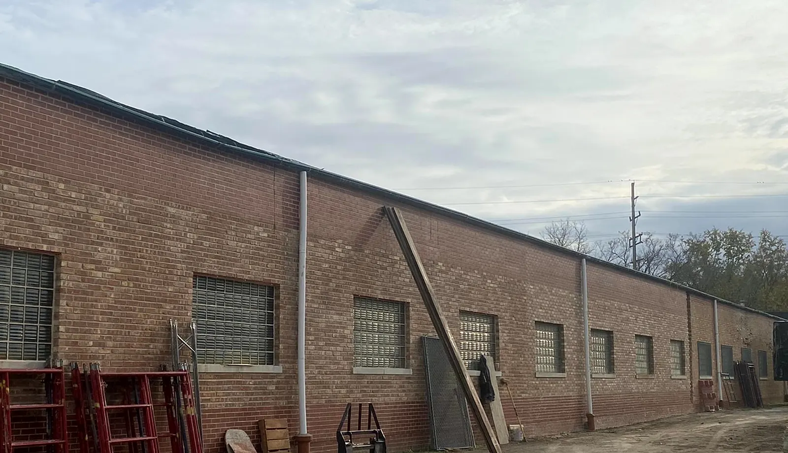 Long industrial façade restored along a Chicagoland service drive